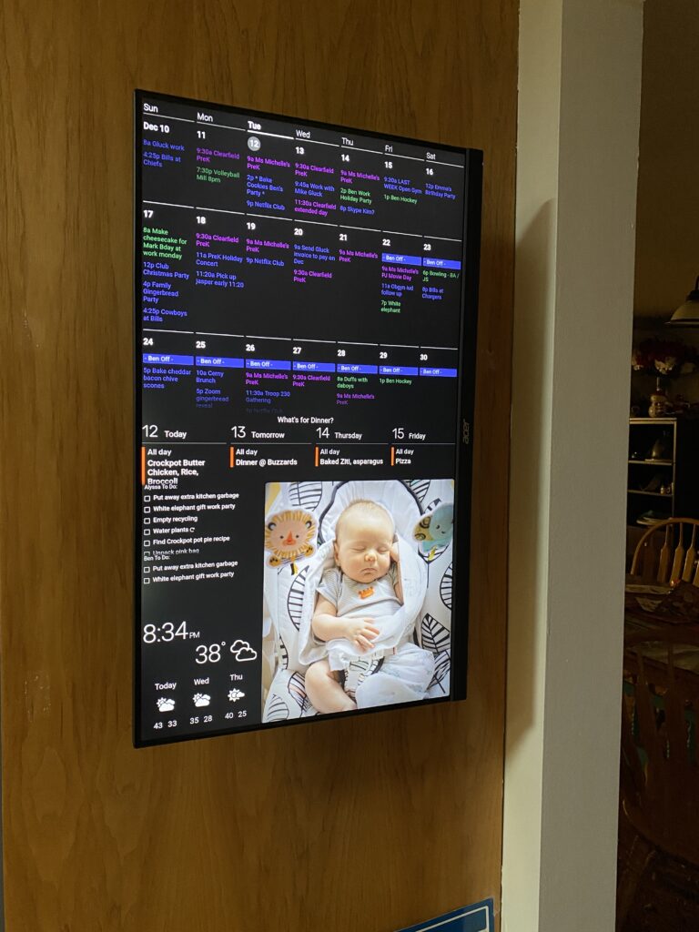 digital display board showing family photos, calendar, to do lists and weather